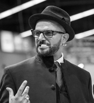 Eddine Belaid presenting on stage – International hairstylist and educator known for innovation and excellence in the beauty industry