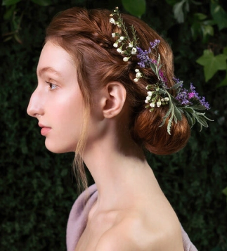 Elegant braided updo with natural floral accessories styled by Eddine Belaid – Romantic bridal hairstyle inspired by nature
