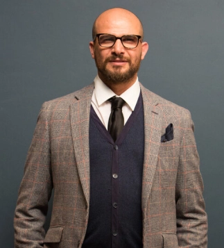 Eddine Belaid in professional attire – Expert hairstylist and salon founder representing excellence and elegance in Swiss beauty industry