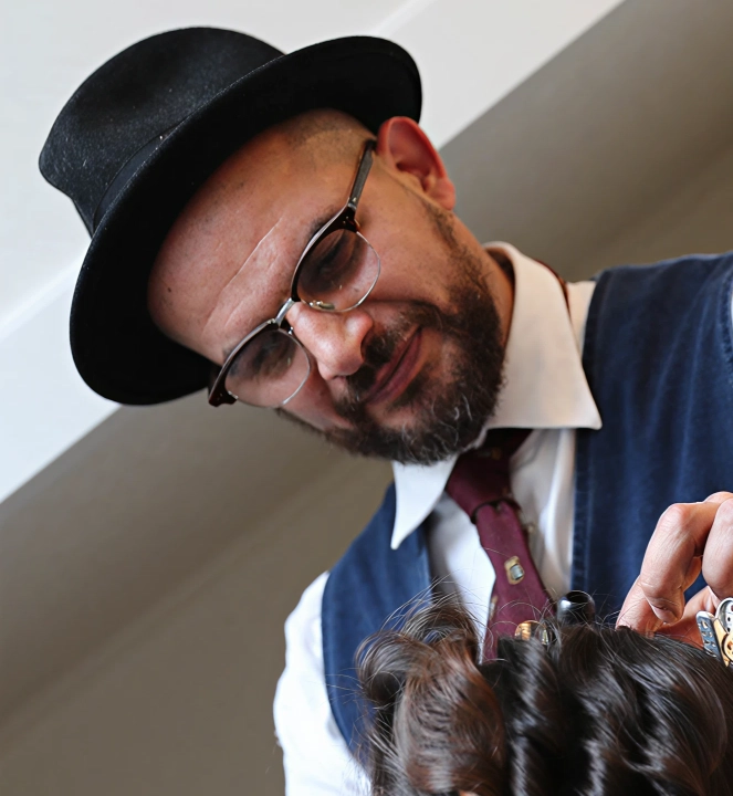 Eddine Belaid styling a client’s hair – Expert hairstylist known for precision, artistry, and luxury salon experience in Switzerland